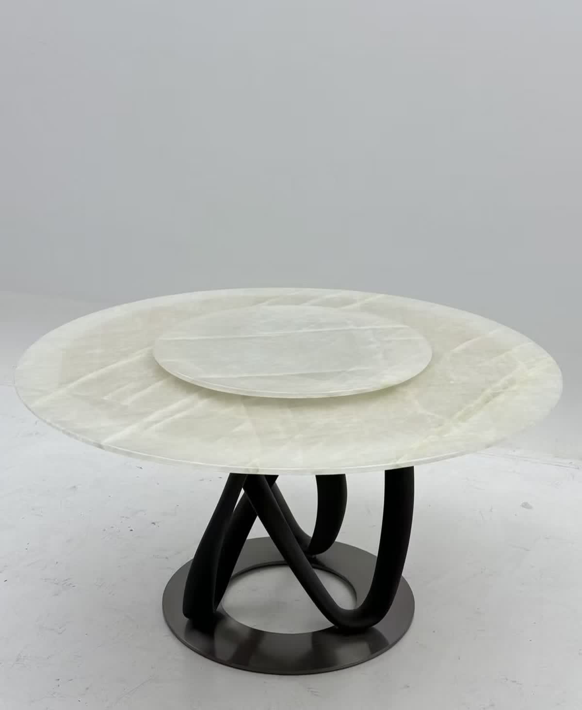 Round dining table with sculptural base — reference photo 1