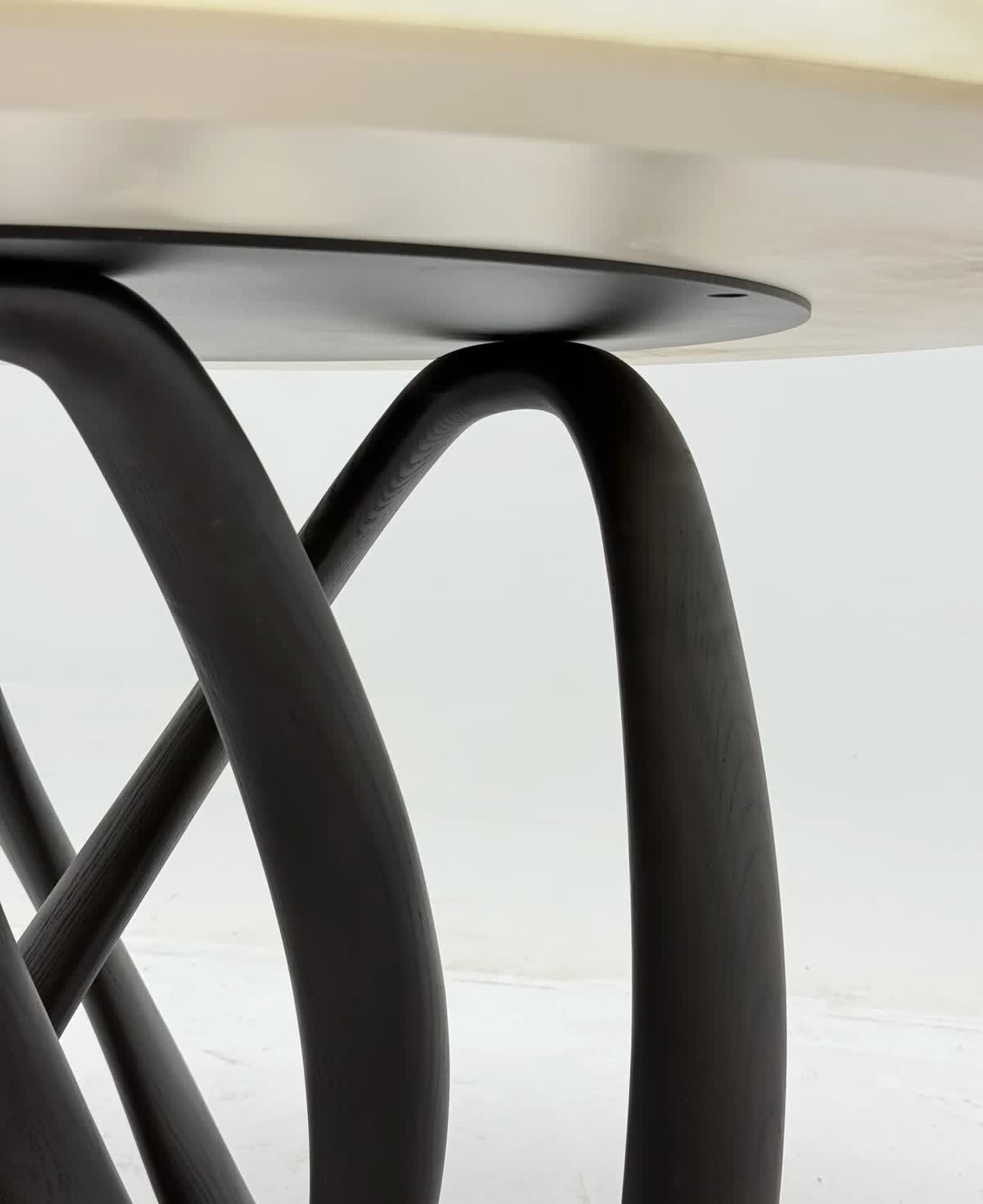 Round dining table with sculptural base — reference photo 3